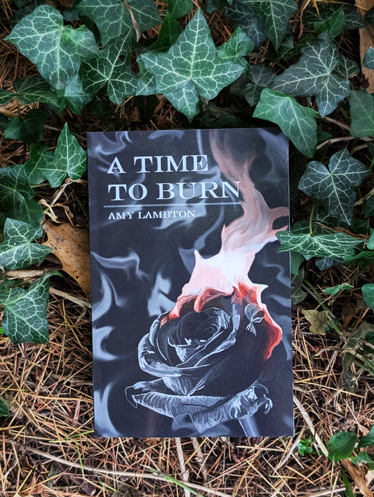 Book titled 'A Time to Burn' by Amy Lambton on a leafy background